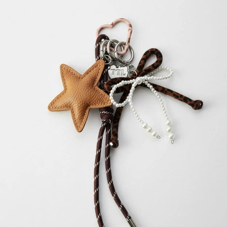 Star-shaped keychain with braided design on a white background