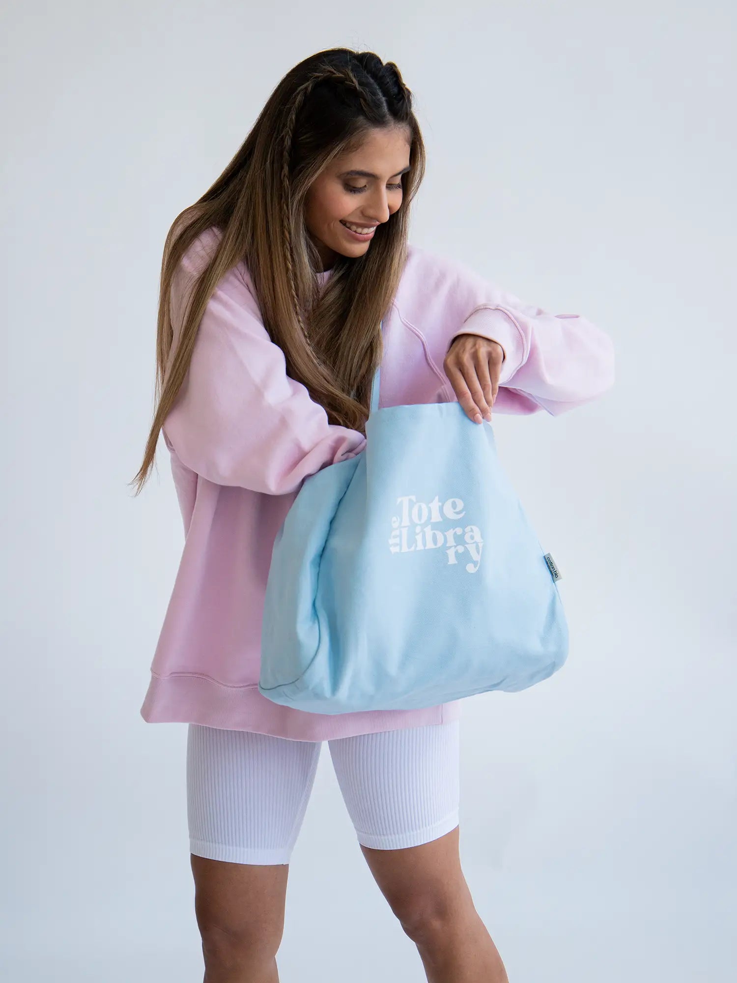 Latin Model wearing the sky blue coastal carryall functional tote bag from The Tote Libray