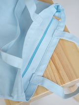 Baby Blue Mini Functional Tote Bag on a chair showcasing the top metal zipper from The Tote Library