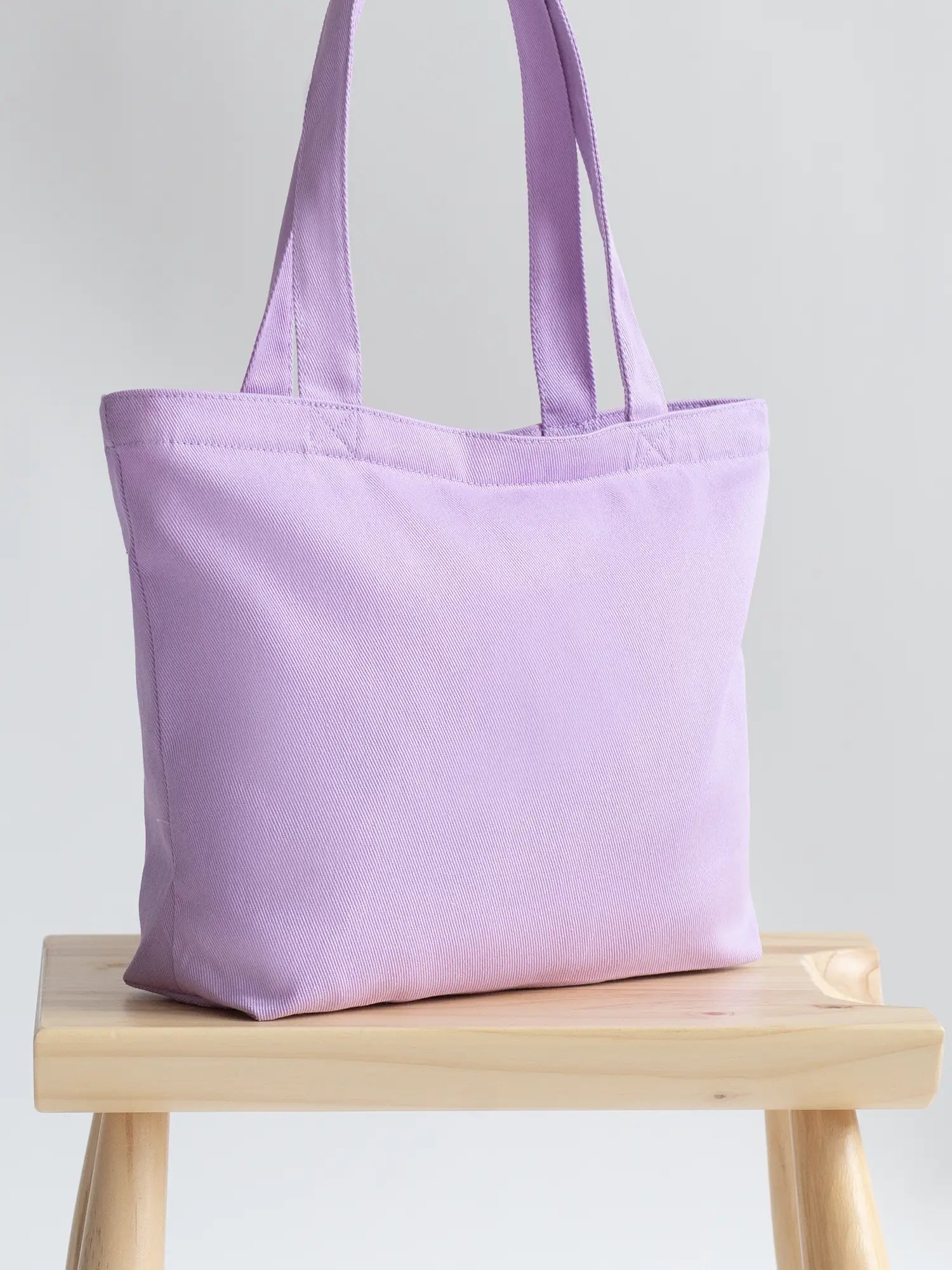 Purple Mini Functional Tote Bag on a chair from The Tote Library