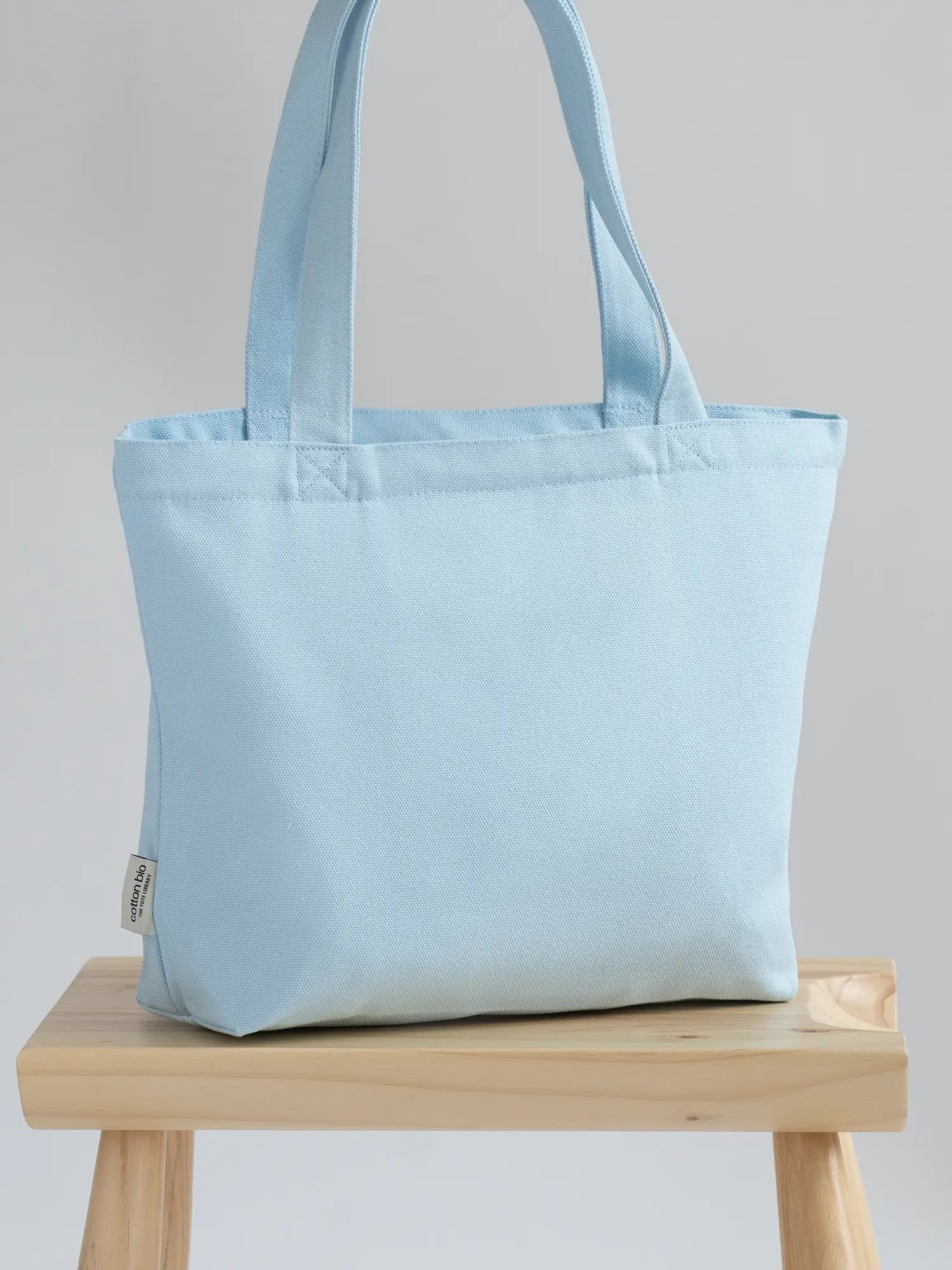 baby blue Mini Functional Tote Bag on a chair from The Tote Library
