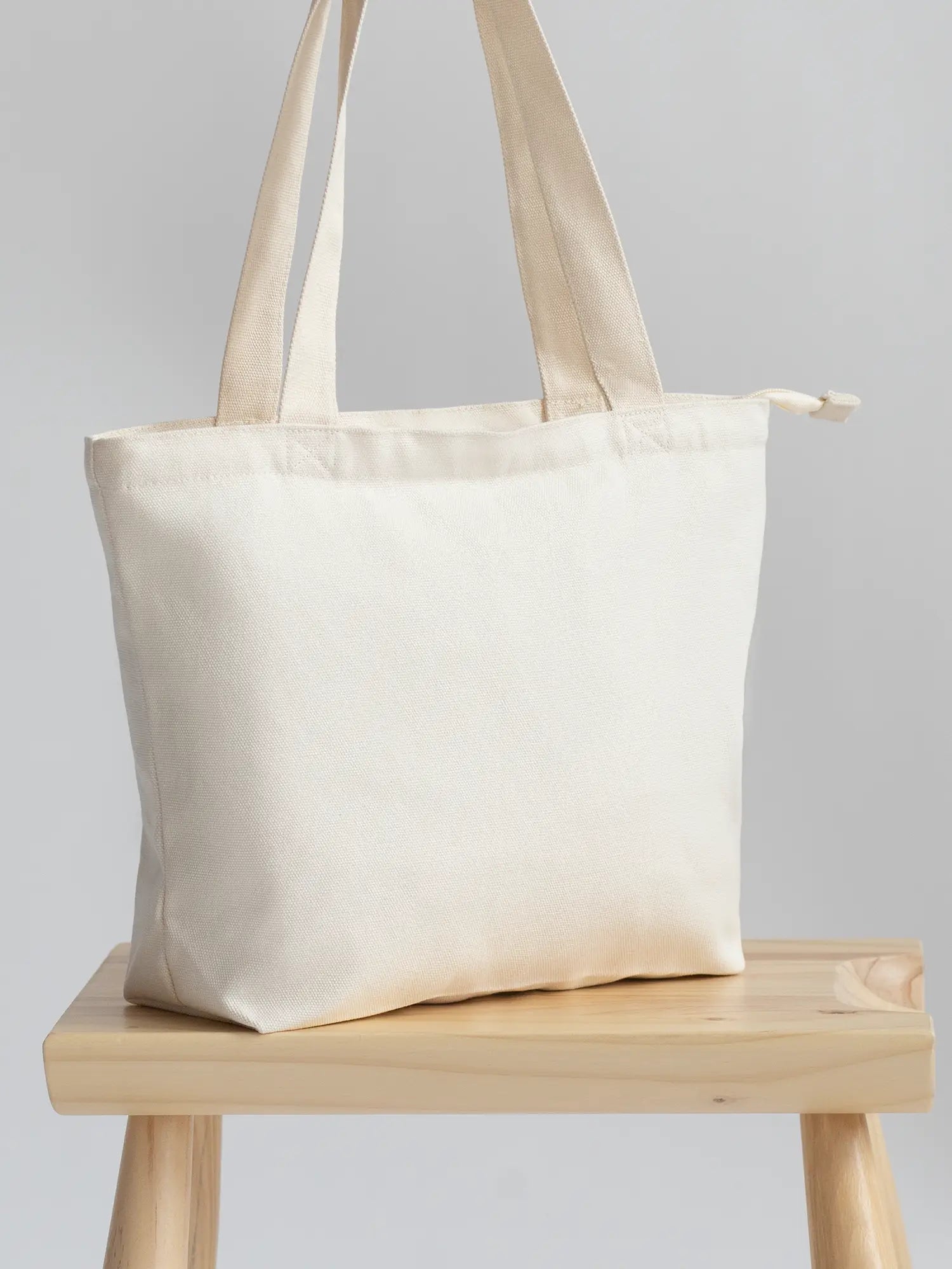 Sand Mini Functional Tote Bag on a chair from The Tote Library